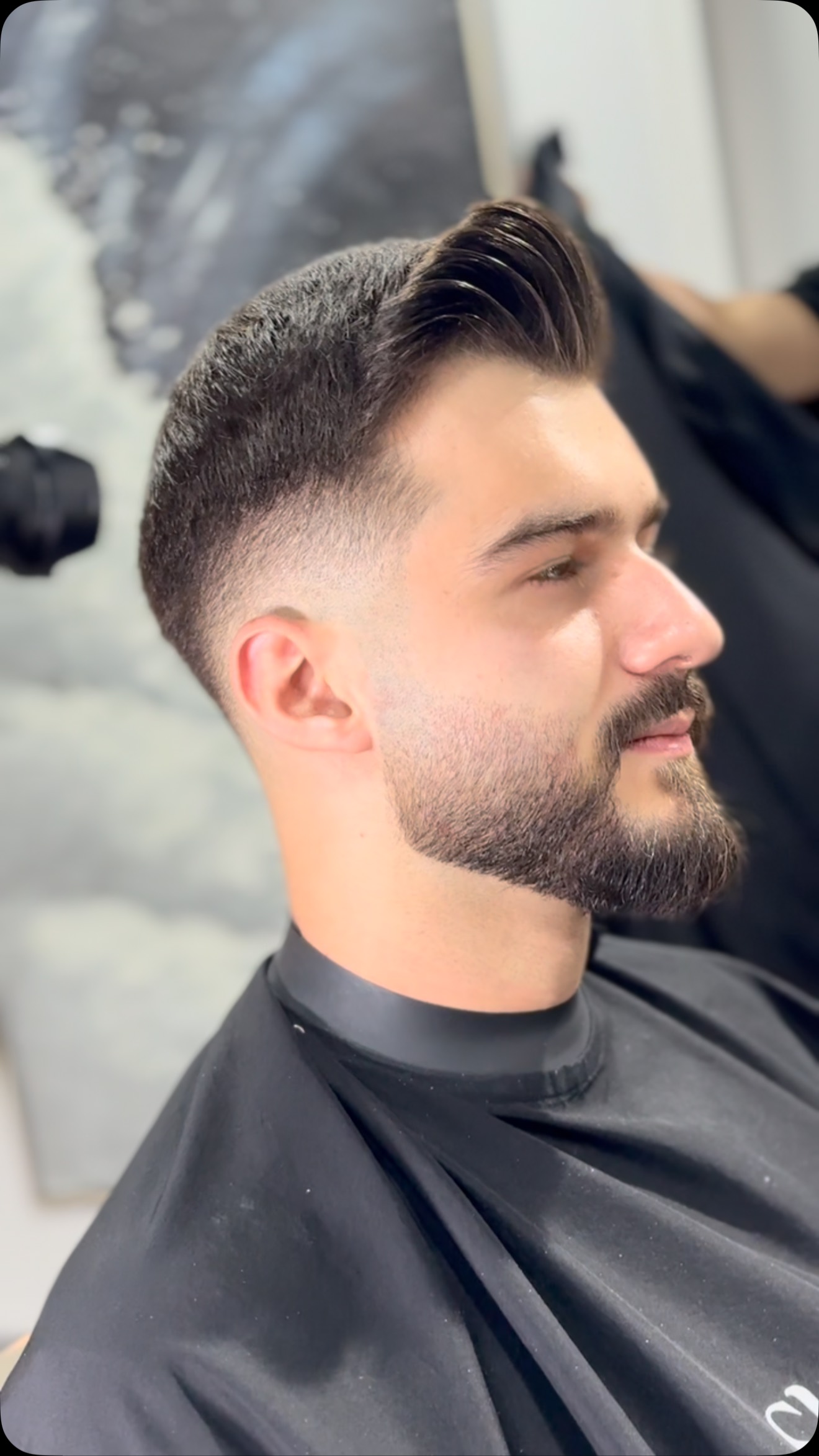Modern fade — three-quarter profile, weight left on top