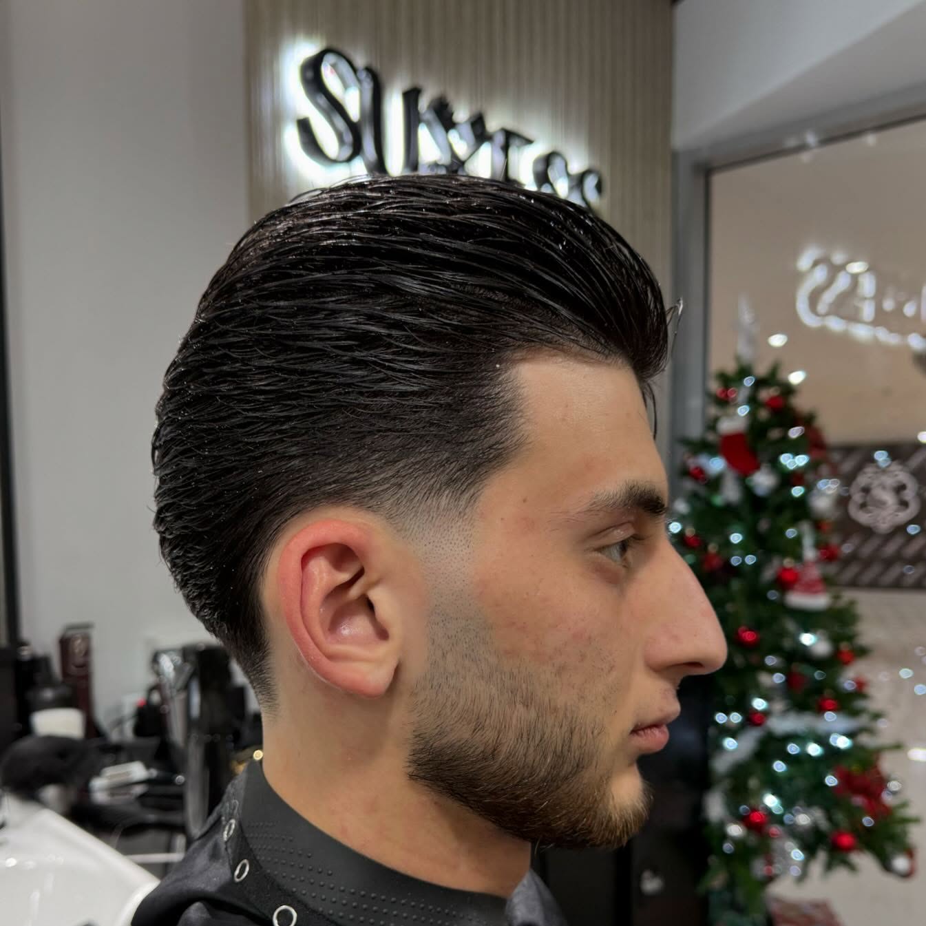 Beard detail — razor line at the cheek, hot towel steam